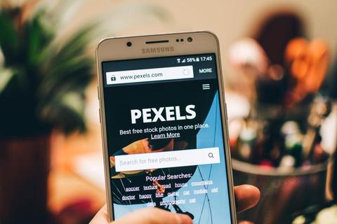 Smartphone in hand with a bright screen